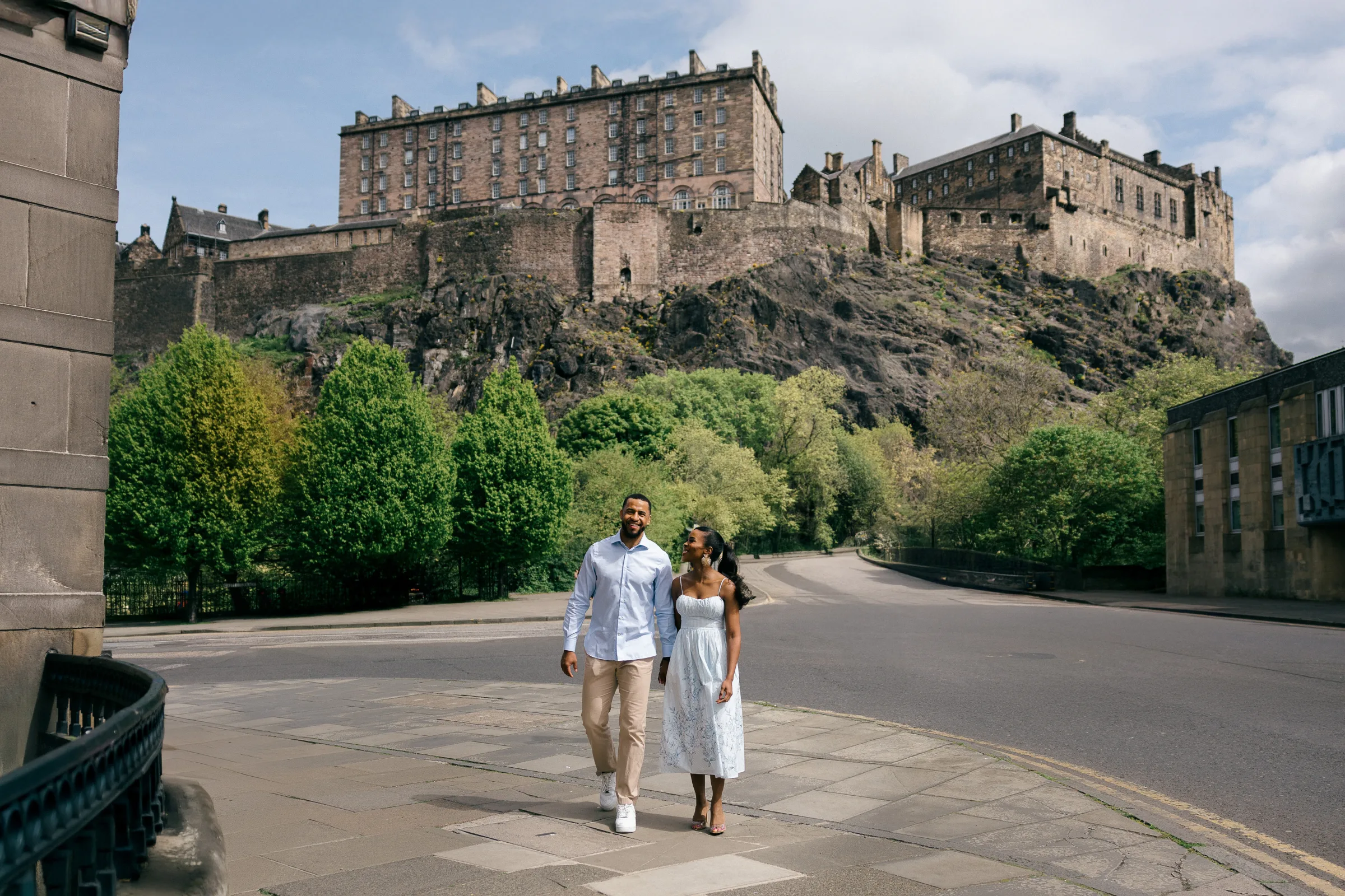 Didi & Anthony hand in hand on the cobbles below Edinburgh Castle.